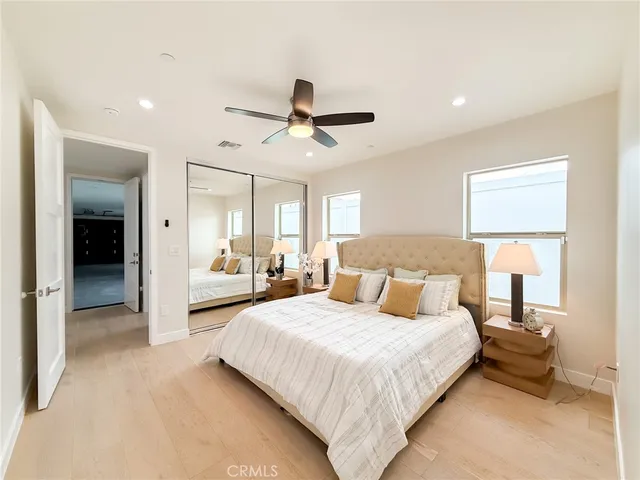 a kitchen with stainless steel appliances granite countertop a refrigerator a stove top oven a sink and dishwasher with wooden floor