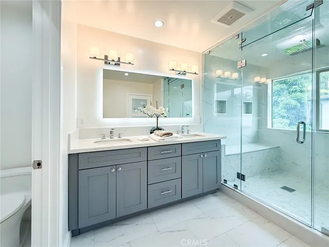 a living room with a couch and a dresser with wooden floor