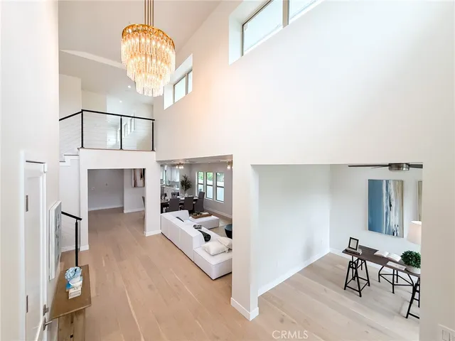 a living room with furniture a fireplace and a chandelier