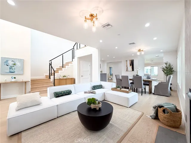 a living room with furniture a fireplace and a potted plant