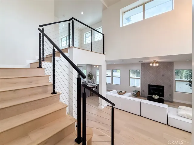 a living room with furniture a fireplace and a table
