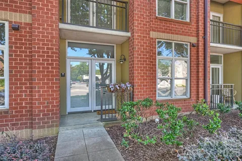 a view of a brick house with a large windows