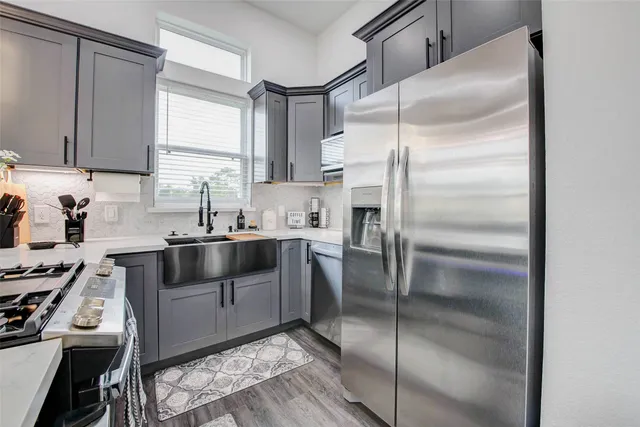 a kitchen with a refrigerator and a sink