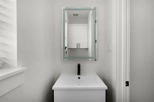 a bathroom with a sink and a mirror