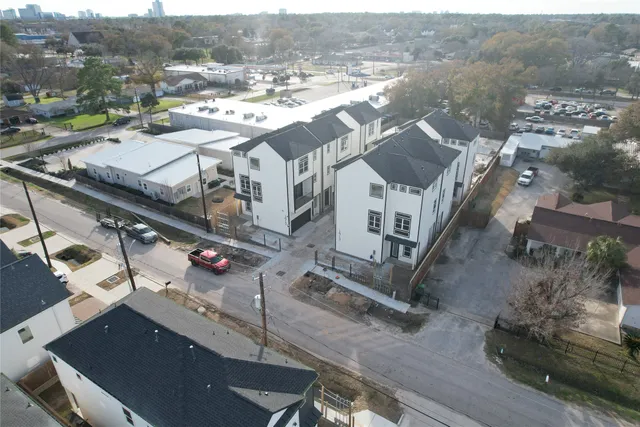 a kitchen with kitchen island granite countertop a sink cabinets and wooden floor
