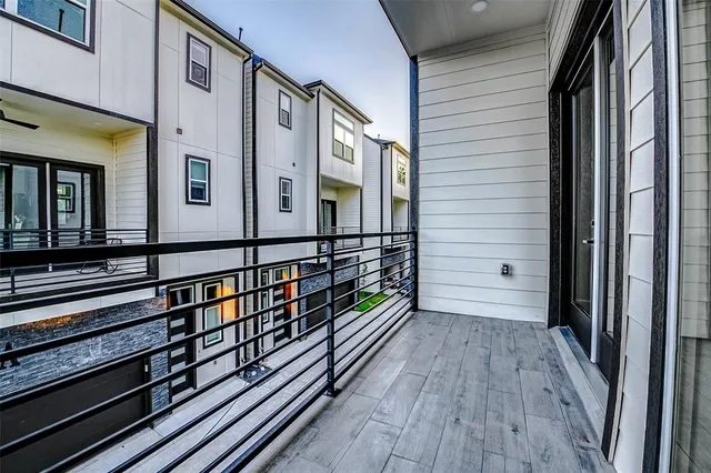 a view of a balcony with wooden floor and stairs