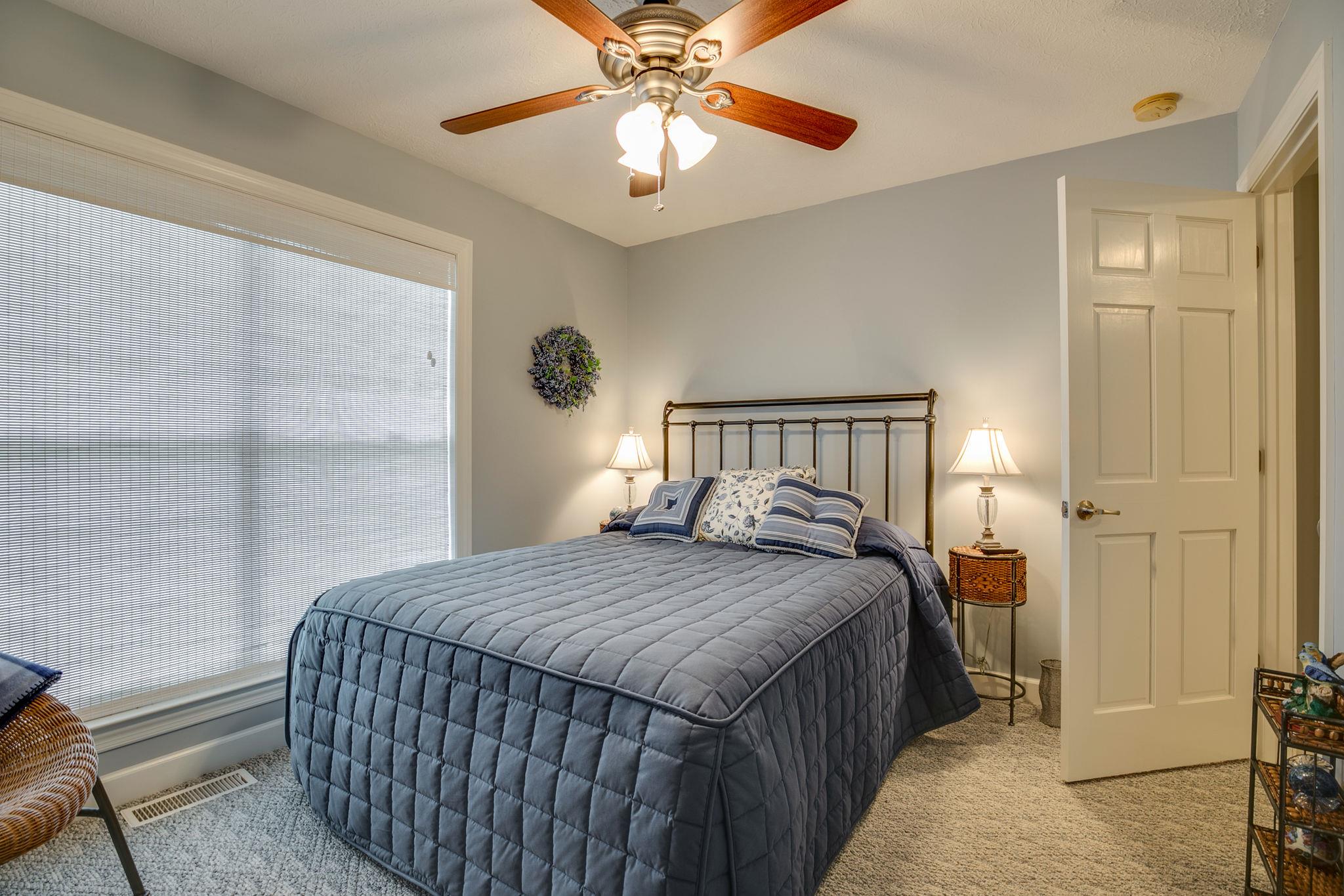 1876 Little Hurricane Road Winchester, TN 37398 - Photo 23 of 30 a bedroom with a bed and a chandelier