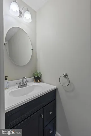 a bathroom with a sink vanity and a mirror