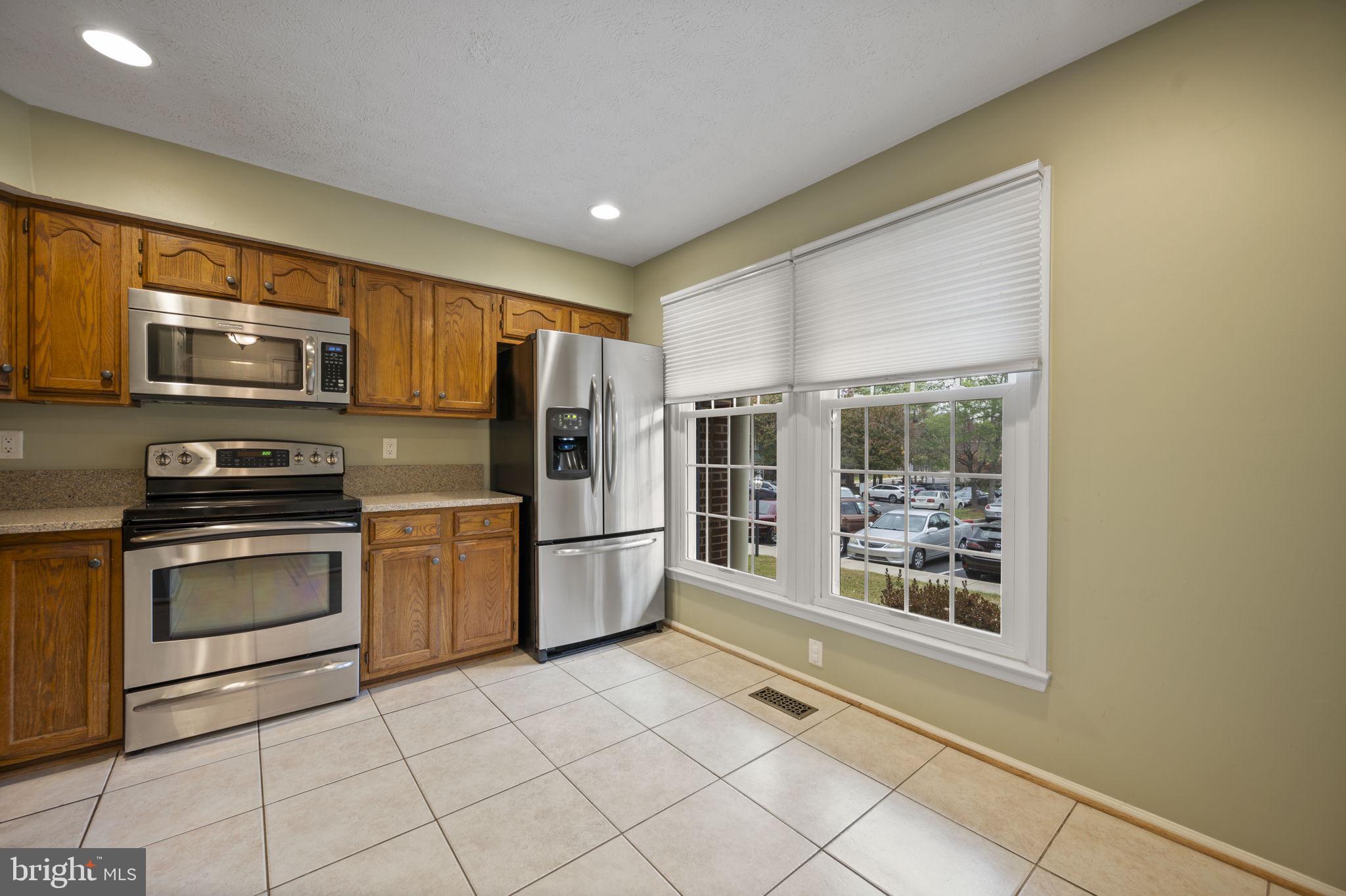 5026 Southern Star Terrace Columbia, MD 21044 - Photo 12 of 47 a kitchen with stainless steel appliances a refrigerator and a stove top oven