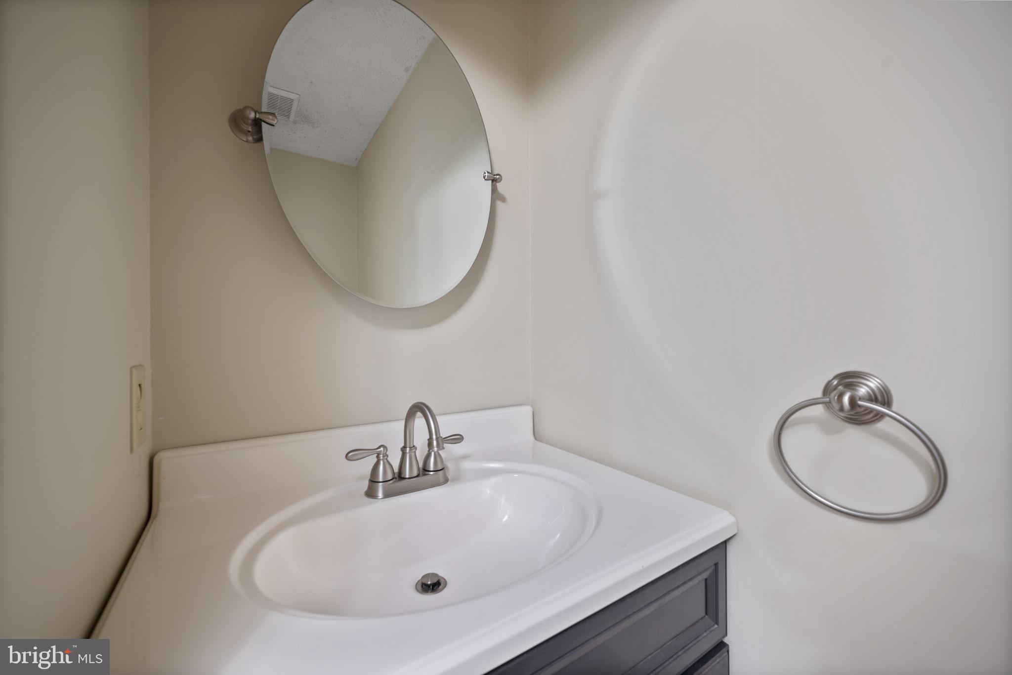5026 Southern Star Terrace Columbia, MD 21044 - Photo 14 of 47 a bathroom with a sink and a mirror