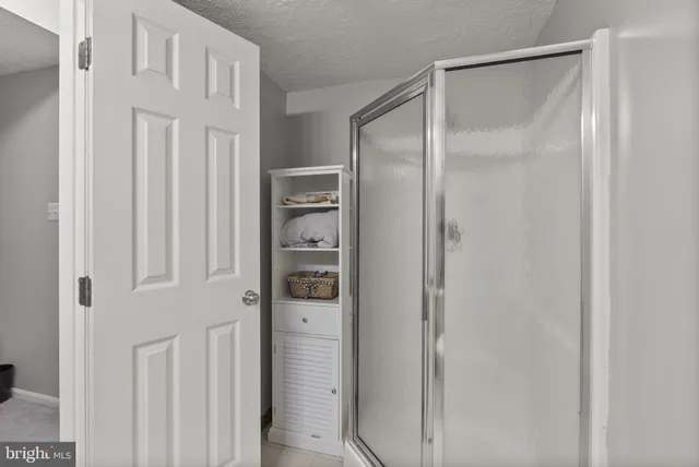 a bathroom with a glass shower door
