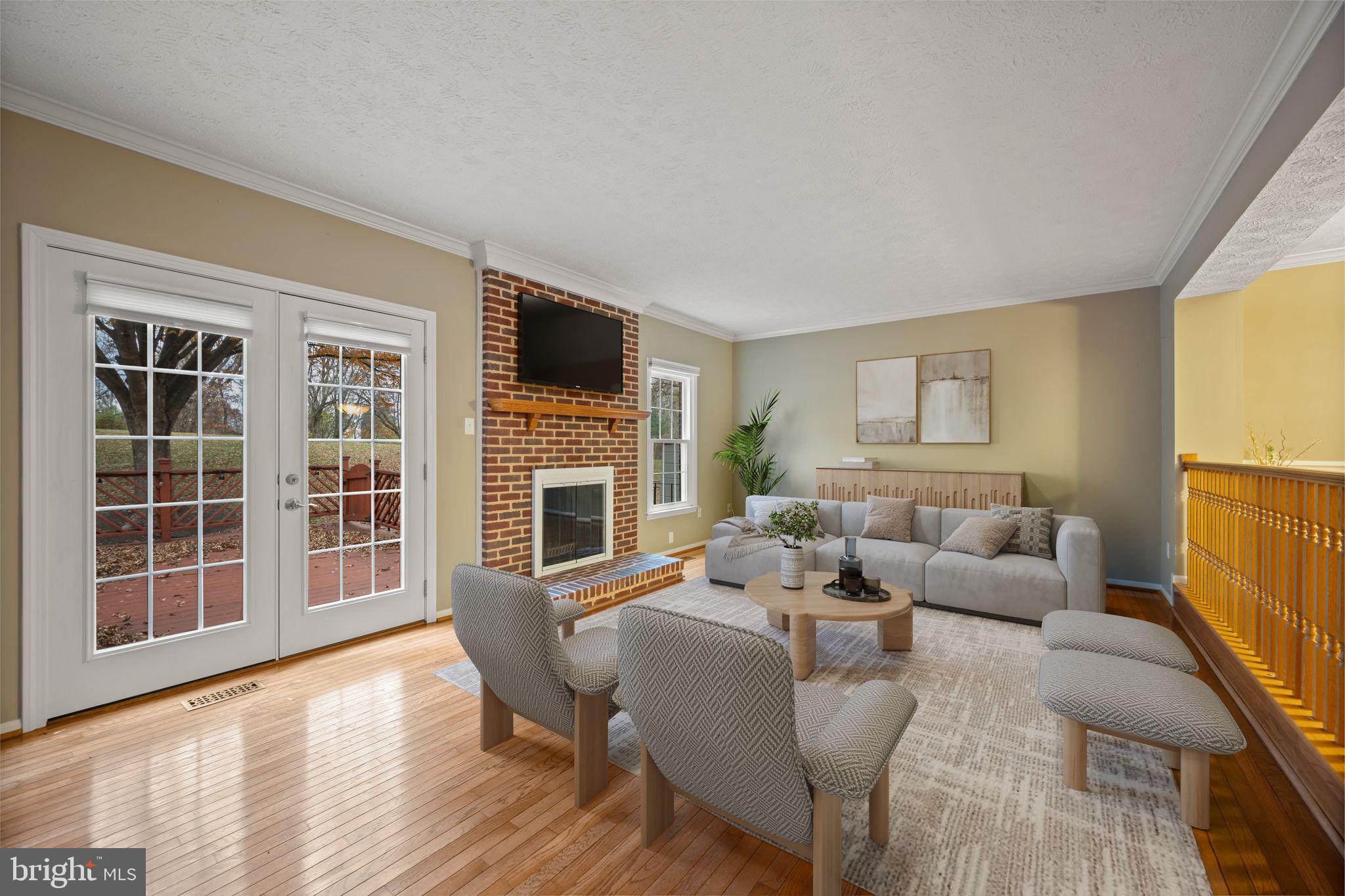 5026 Southern Star Terrace Columbia, MD 21044 - Photo 3 of 47 a living room with furniture a fireplace and a flat screen tv