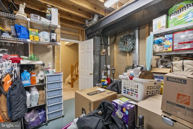 a utility room with stainless steel appliances and living room view