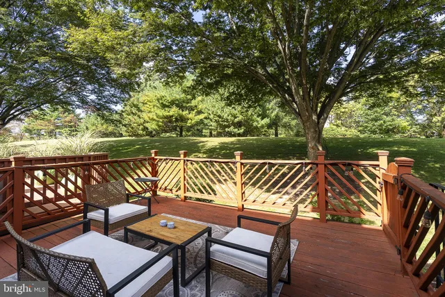 a balcony with wooden floor and outdoor seating