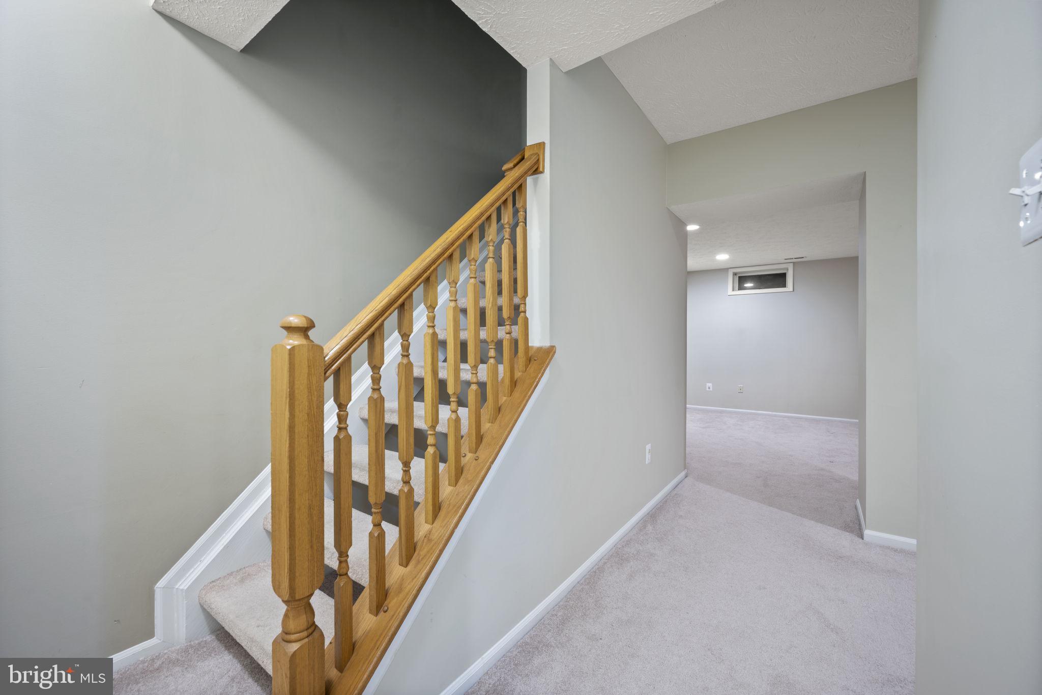 5026 Southern Star Terrace Columbia, MD 21044 - Photo 33 of 47 a view of staircase with wooden floor and white walls