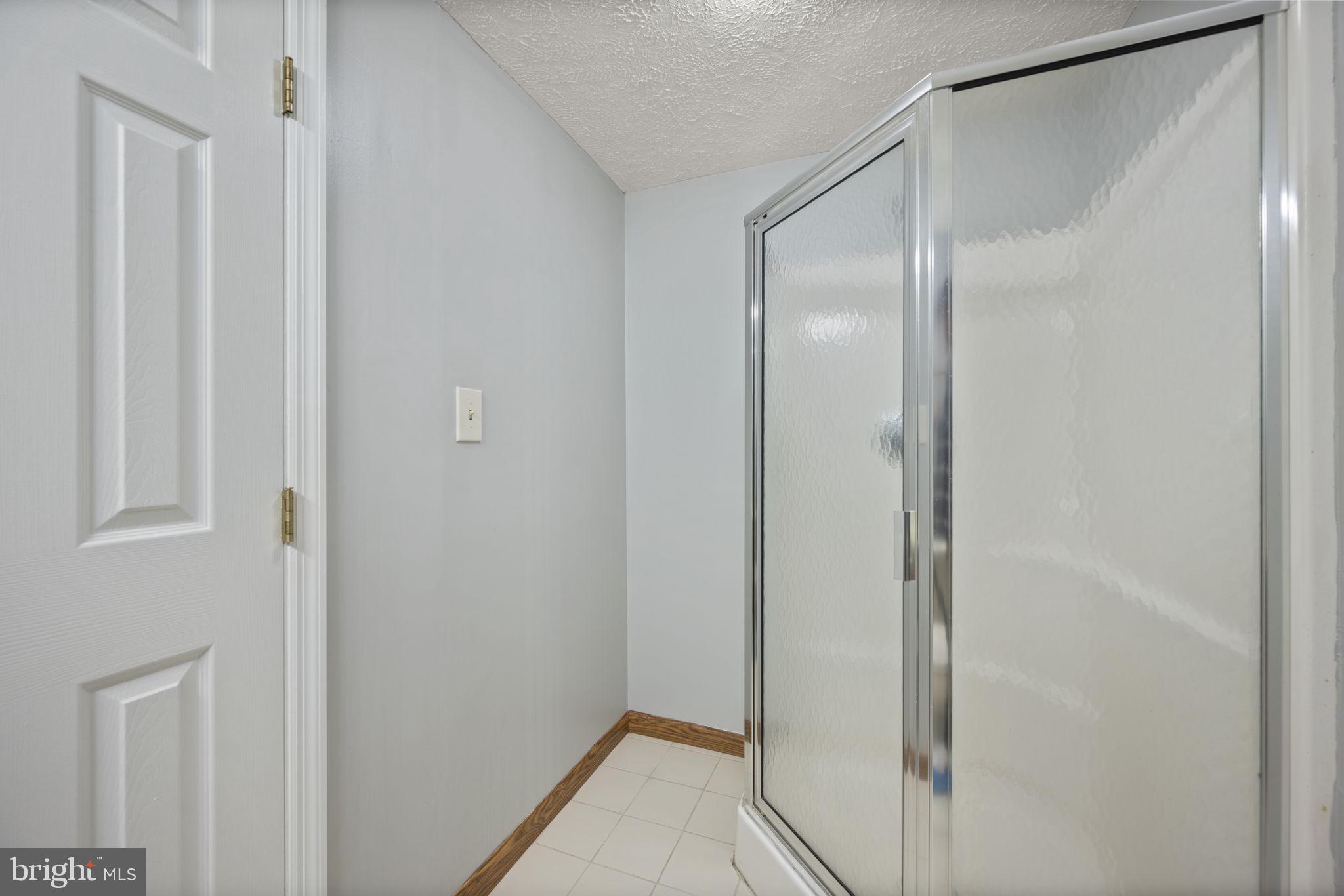 5026 Southern Star Terrace Columbia, MD 21044 - Photo 35 of 47 a bathroom with a glass shower door