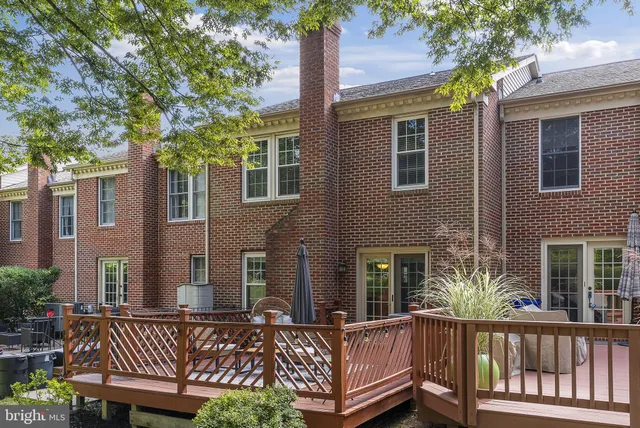 a view of a house with a wooden fence