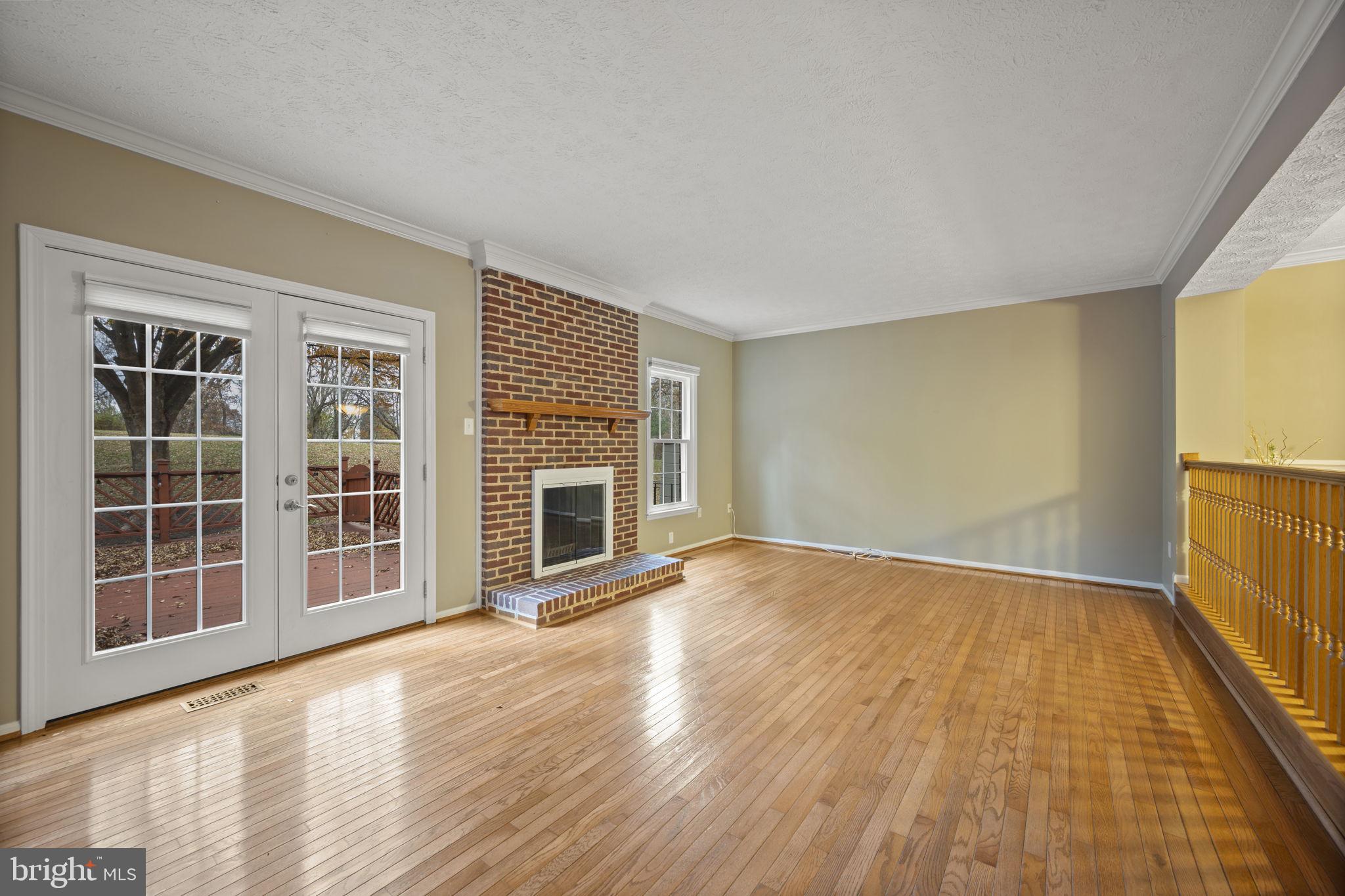 5026 Southern Star Terrace Columbia, MD 21044 - Photo 5 of 47 a view of an empty room with wooden floor and a window