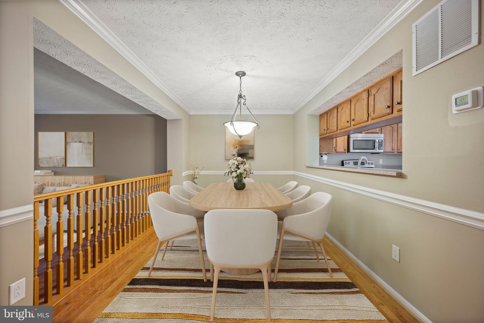 5026 Southern Star Terrace Columbia, MD 21044 - Photo 6 of 47 a view of a dining room with furniture window and wooden floor
