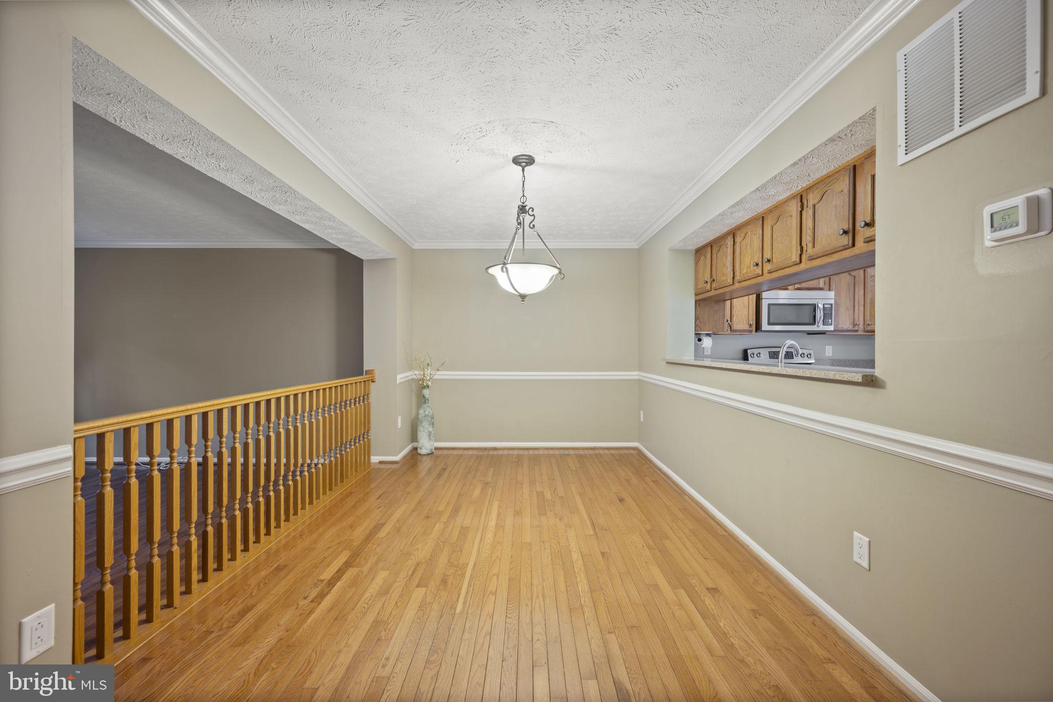 5026 Southern Star Terrace Columbia, MD 21044 - Photo 7 of 47 a view of a hallway with wooden floor