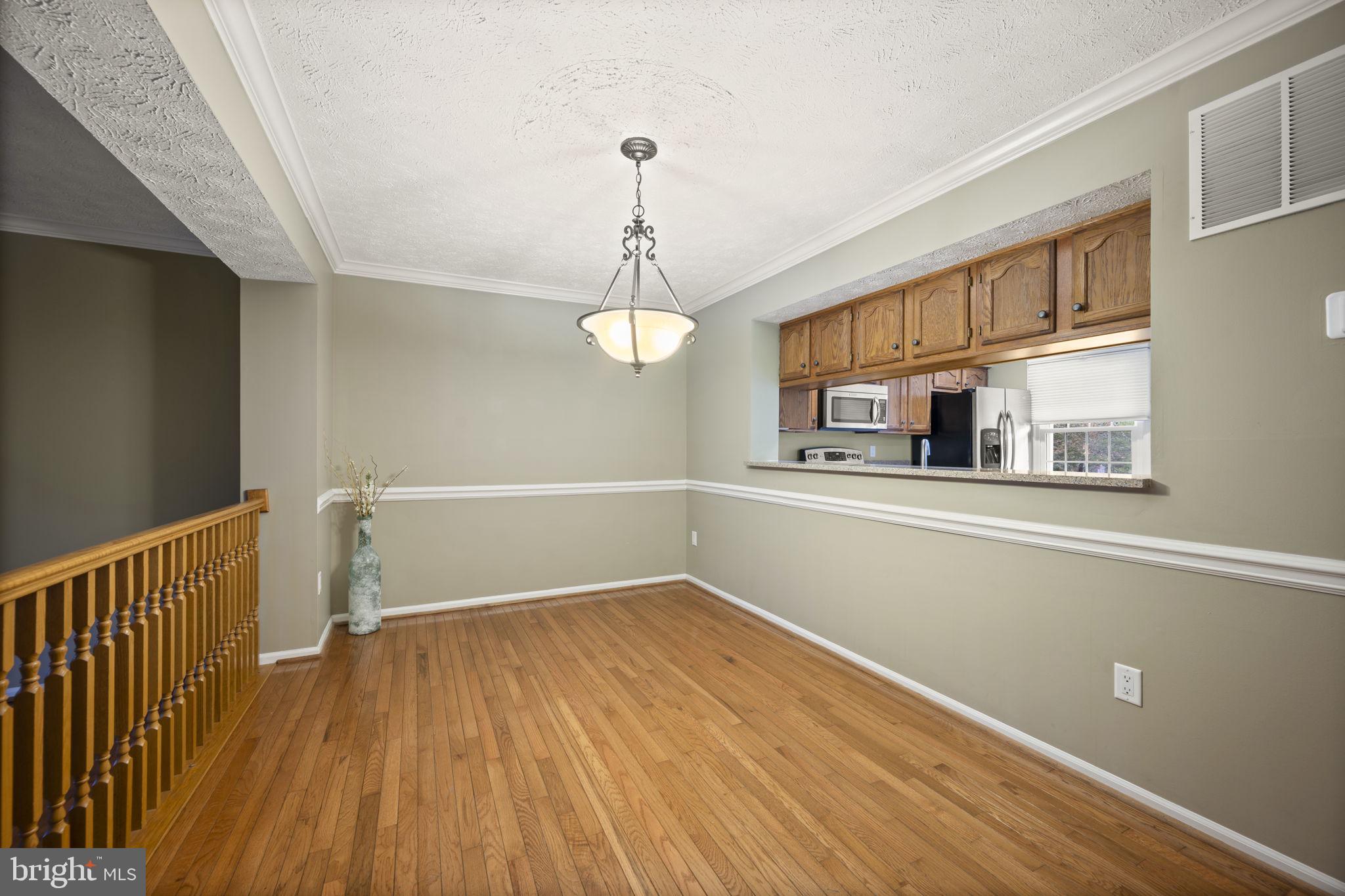 5026 Southern Star Terrace Columbia, MD 21044 - Photo 8 of 47 wooden floor in an empty room with a window