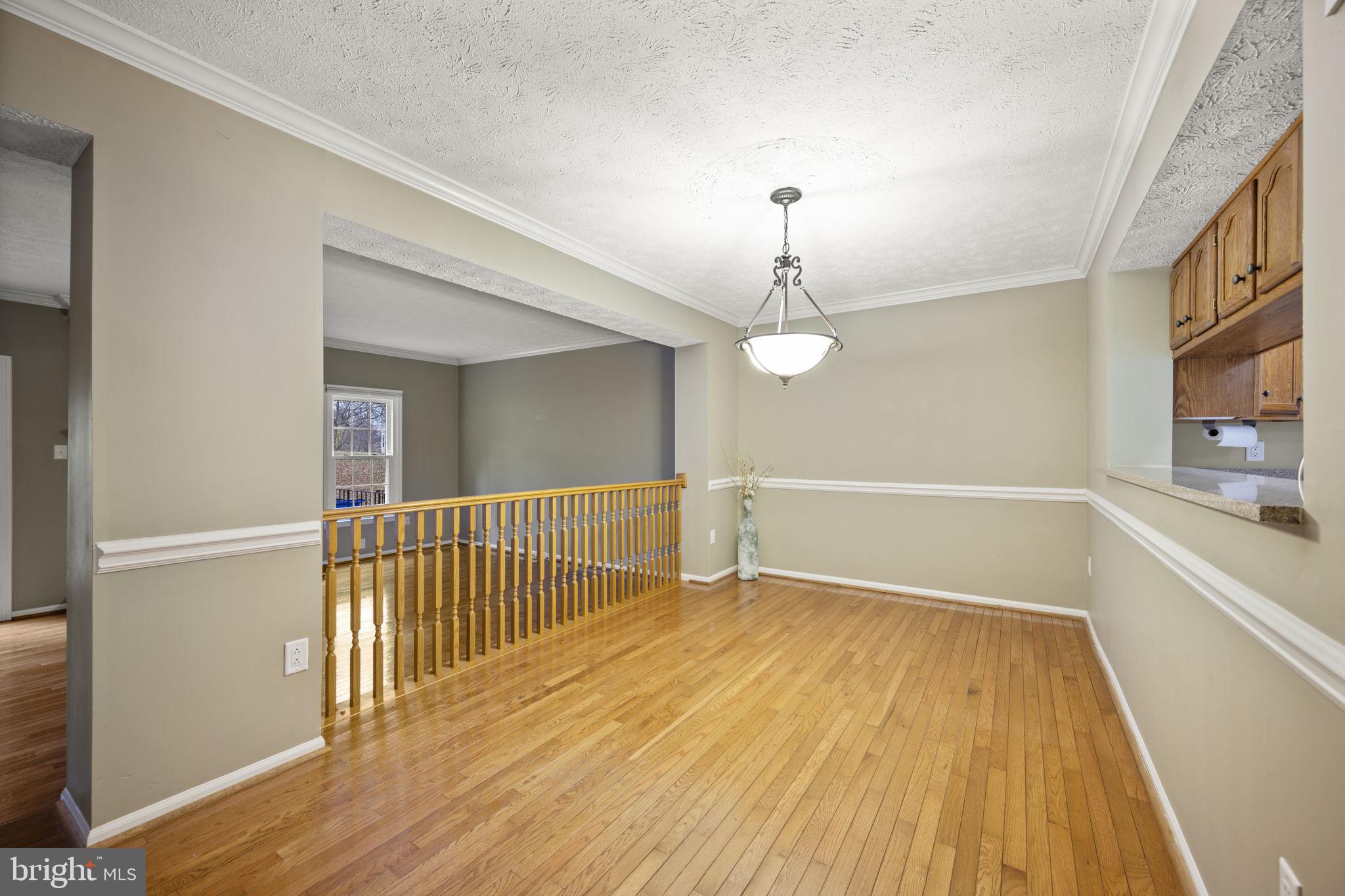 5026 Southern Star Terrace Columbia, MD 21044 - Photo 9 of 47 a view of a room with wooden floor chandelier and entryway