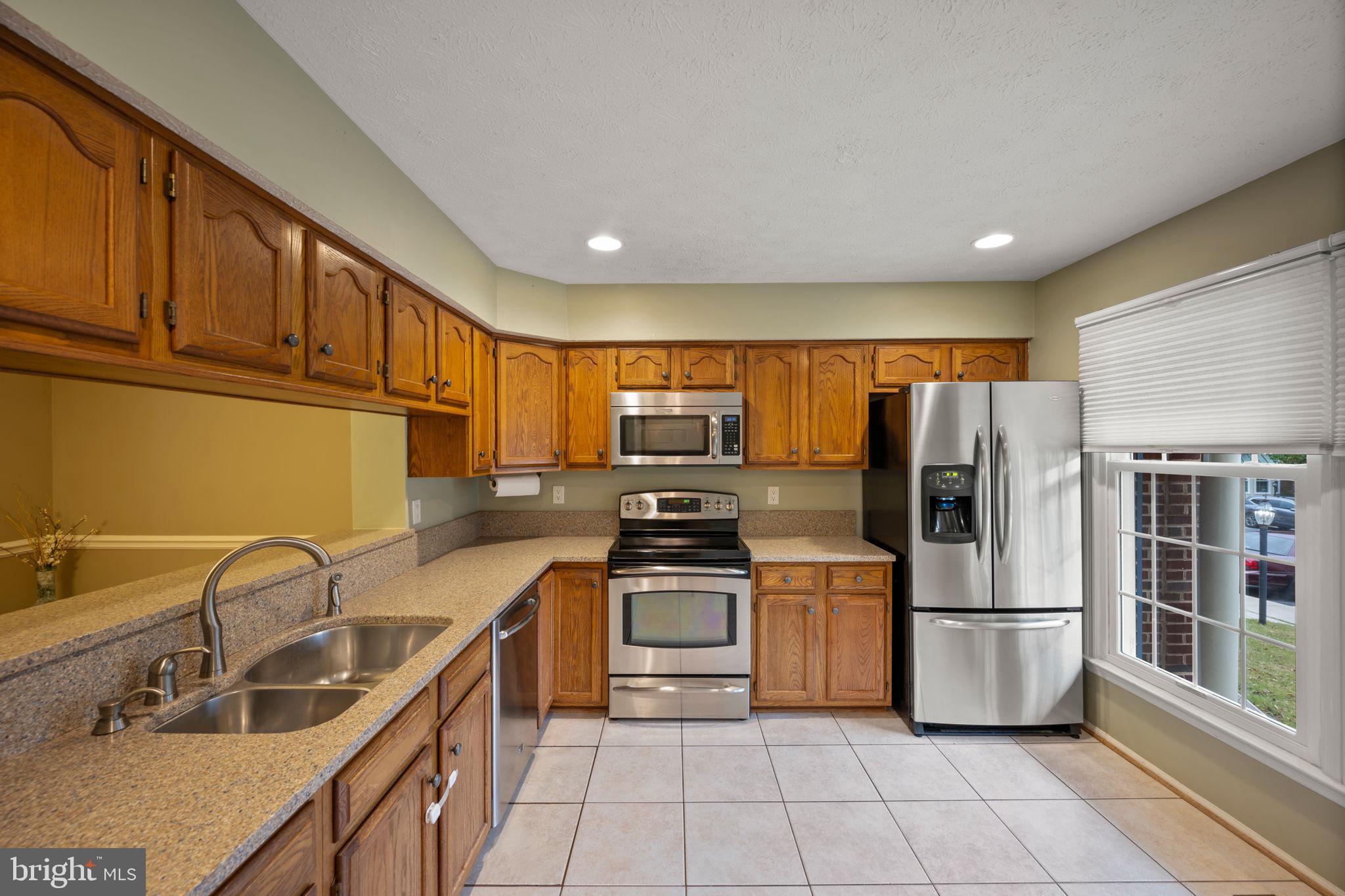 5026 Southern Star Terrace Columbia, MD 21044 - Photo 10 of 47 a kitchen with stainless steel appliances granite countertop a refrigerator sink and stove