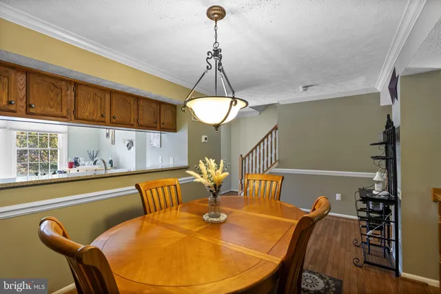 a view of a dining room with furniture and chandelier