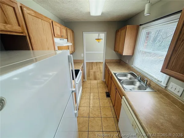 a kitchen with a sink a stove and a refrigerator
