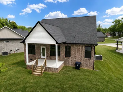 a aerial view of a house next to a big yard