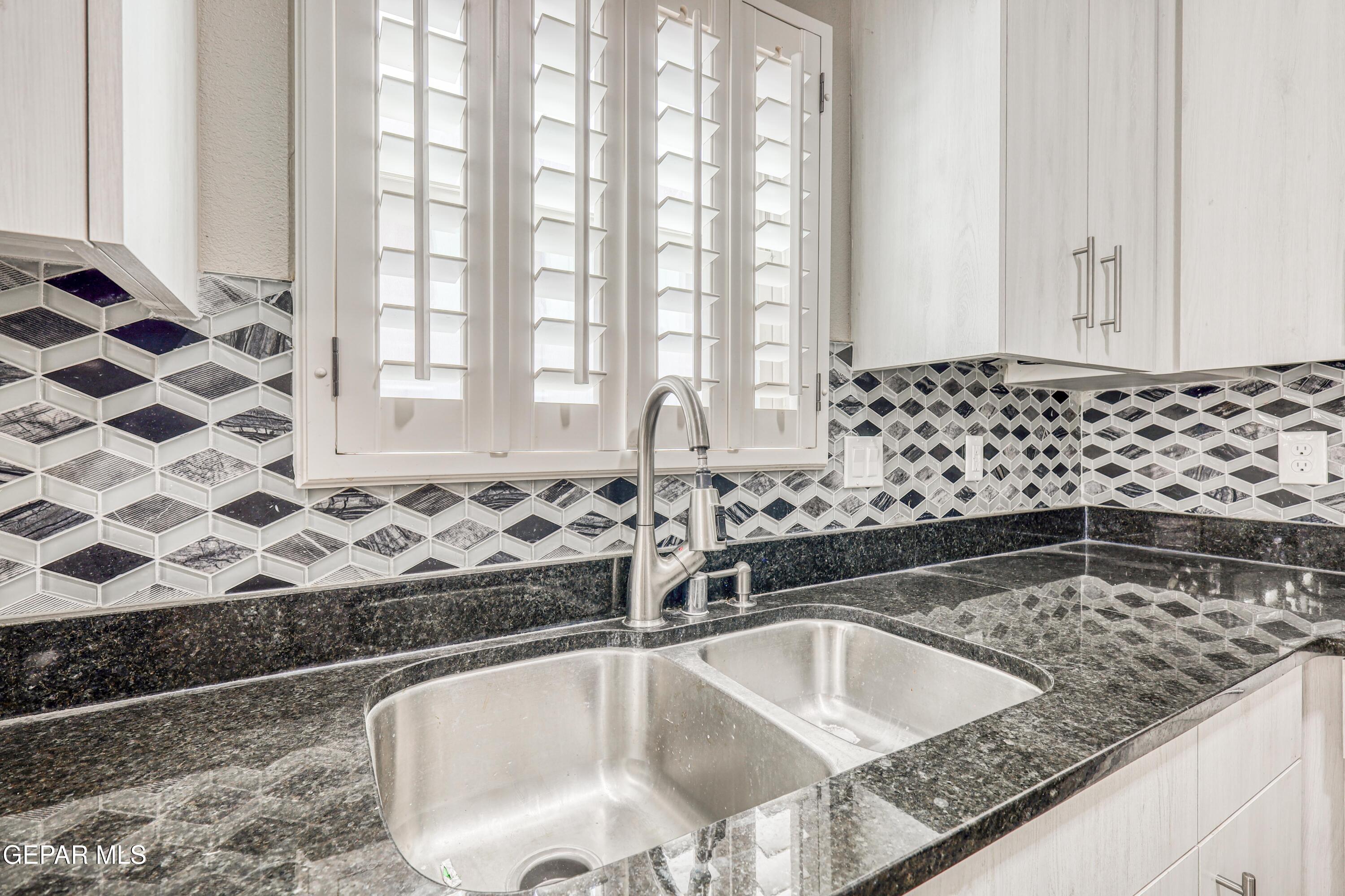 964 Penrith Street El Paso, TX 79928 - Photo 13 of 62 a bathroom with a granite countertop sink a mirror and a bathtub