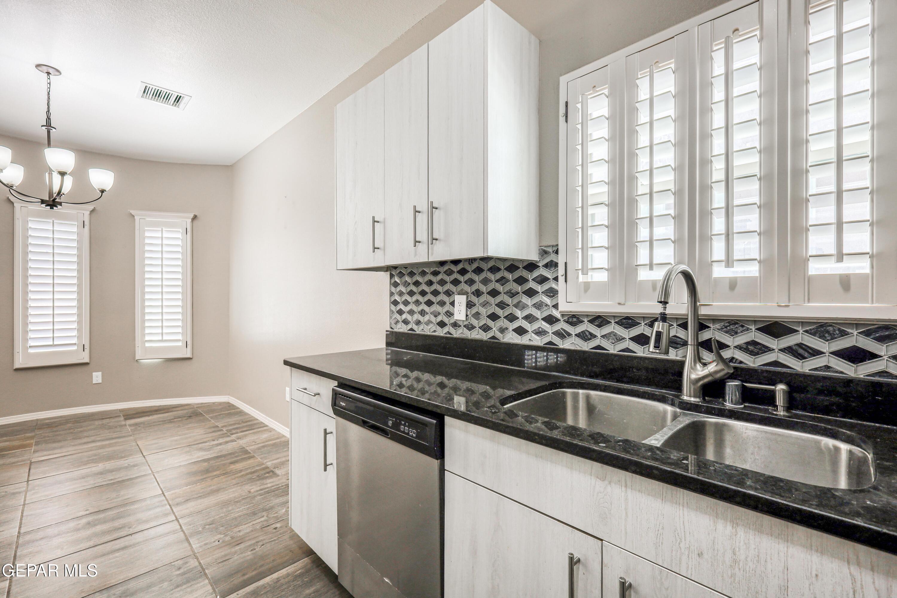 964 Penrith Street El Paso, TX 79928 - Photo 14 of 62 a kitchen with granite countertop a sink and a window