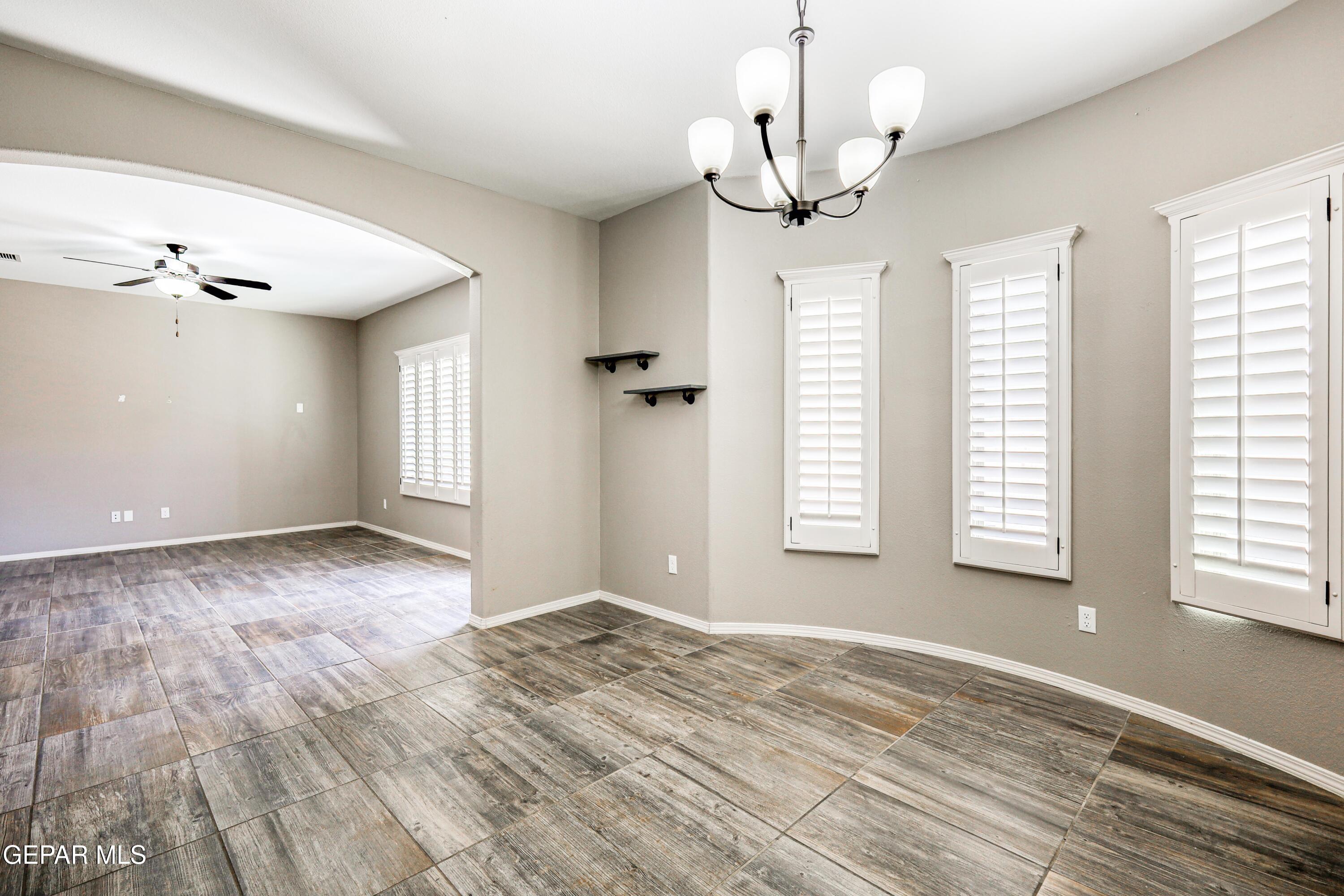 964 Penrith Street El Paso, TX 79928 - Photo 18 of 62 a view of an empty room with a window and wooden floor
