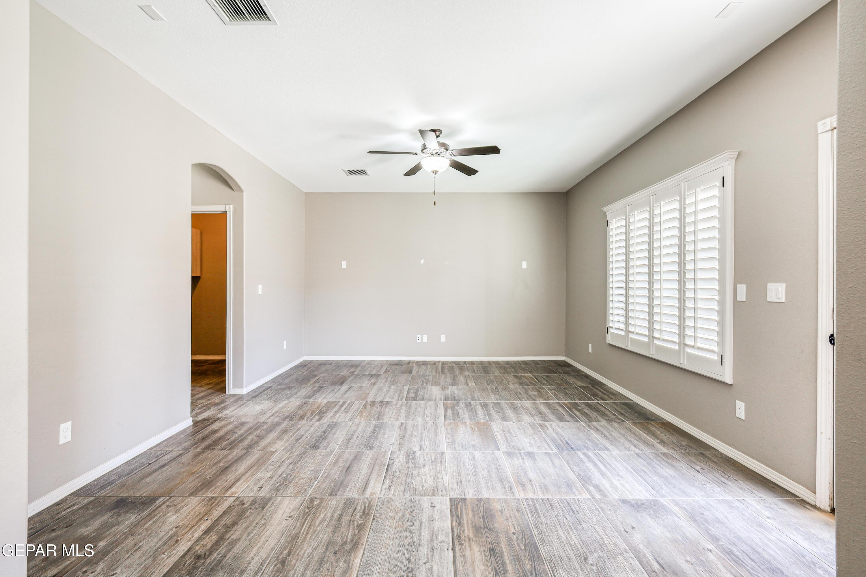 964 Penrith Street El Paso, TX 79928 - Photo 21 of 62 wooden floor in an empty room with a window