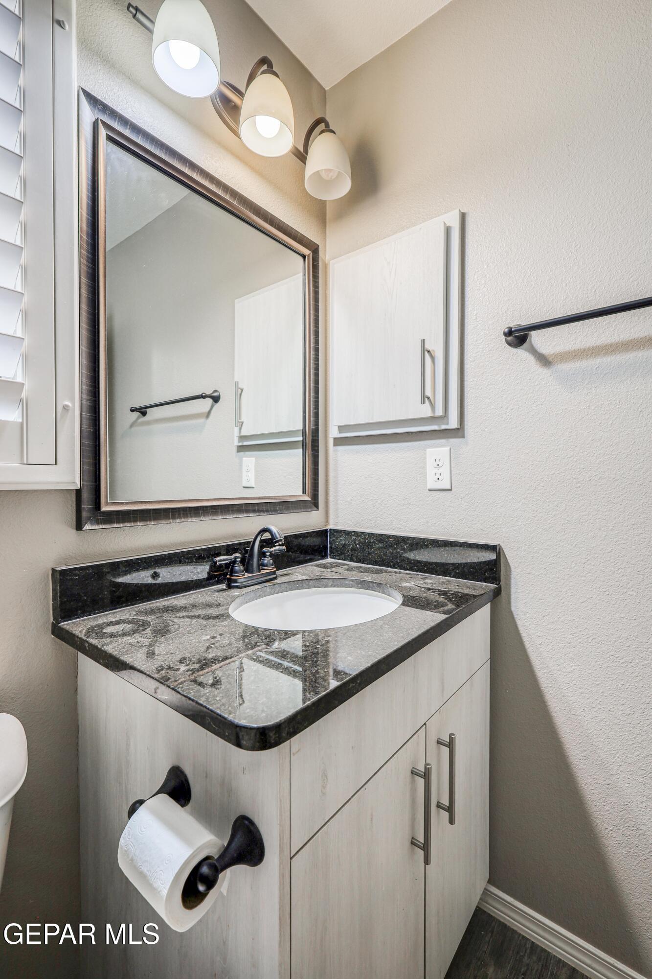 964 Penrith Street El Paso, TX 79928 - Photo 27 of 62 a bathroom with a sink and a mirror