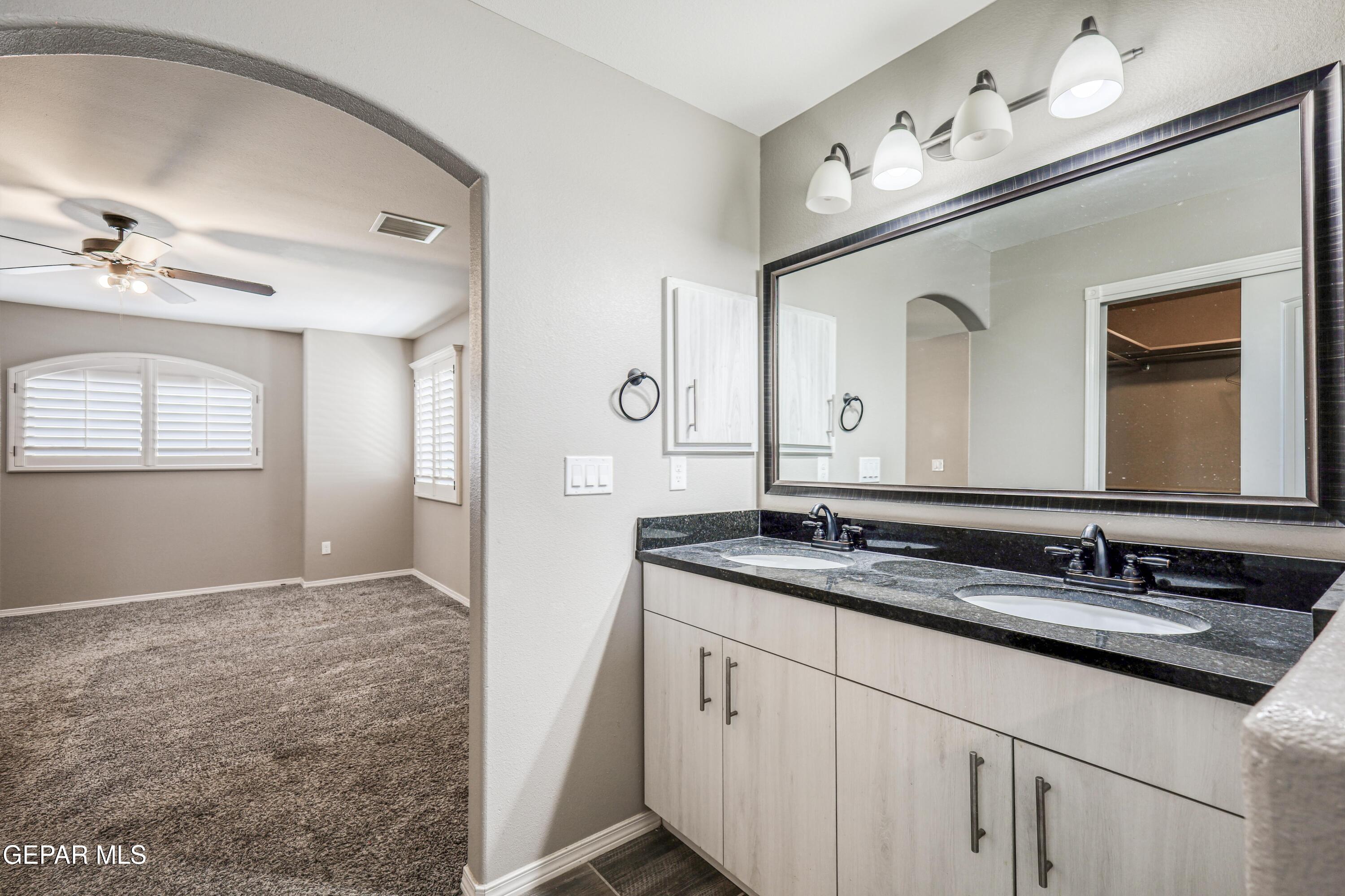 964 Penrith Street El Paso, TX 79928 - Photo 39 of 62 a bathroom with a sink vanity and mirror