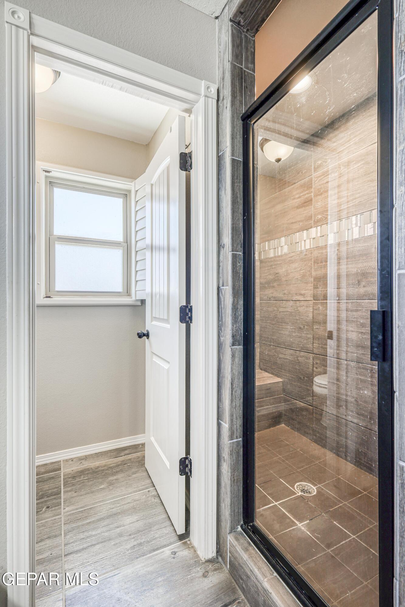 964 Penrith Street El Paso, TX 79928 - Photo 44 of 62 a bathroom with a glass shower door