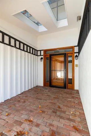 a view of an empty room with a fireplace and a window