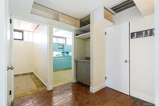 a kitchen with cabinets and window