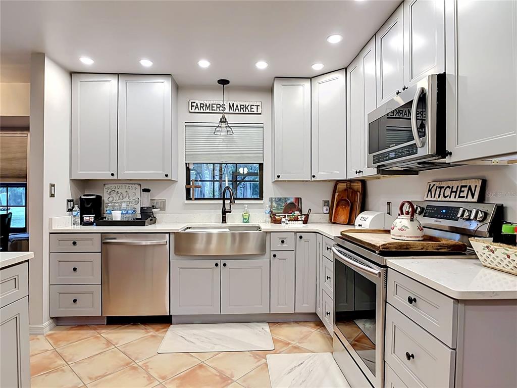 1395 Maytown Road Osteen, FL 32764 - Photo 25 of 65 a kitchen with stainless steel appliances granite countertop a sink and cabinets