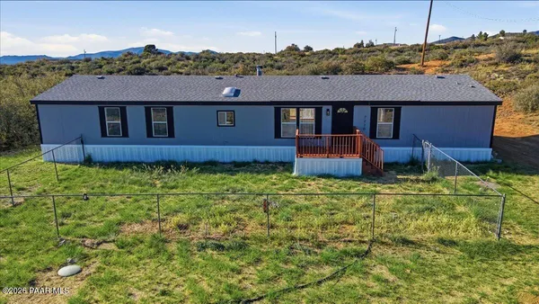 a view of a house with a backyard