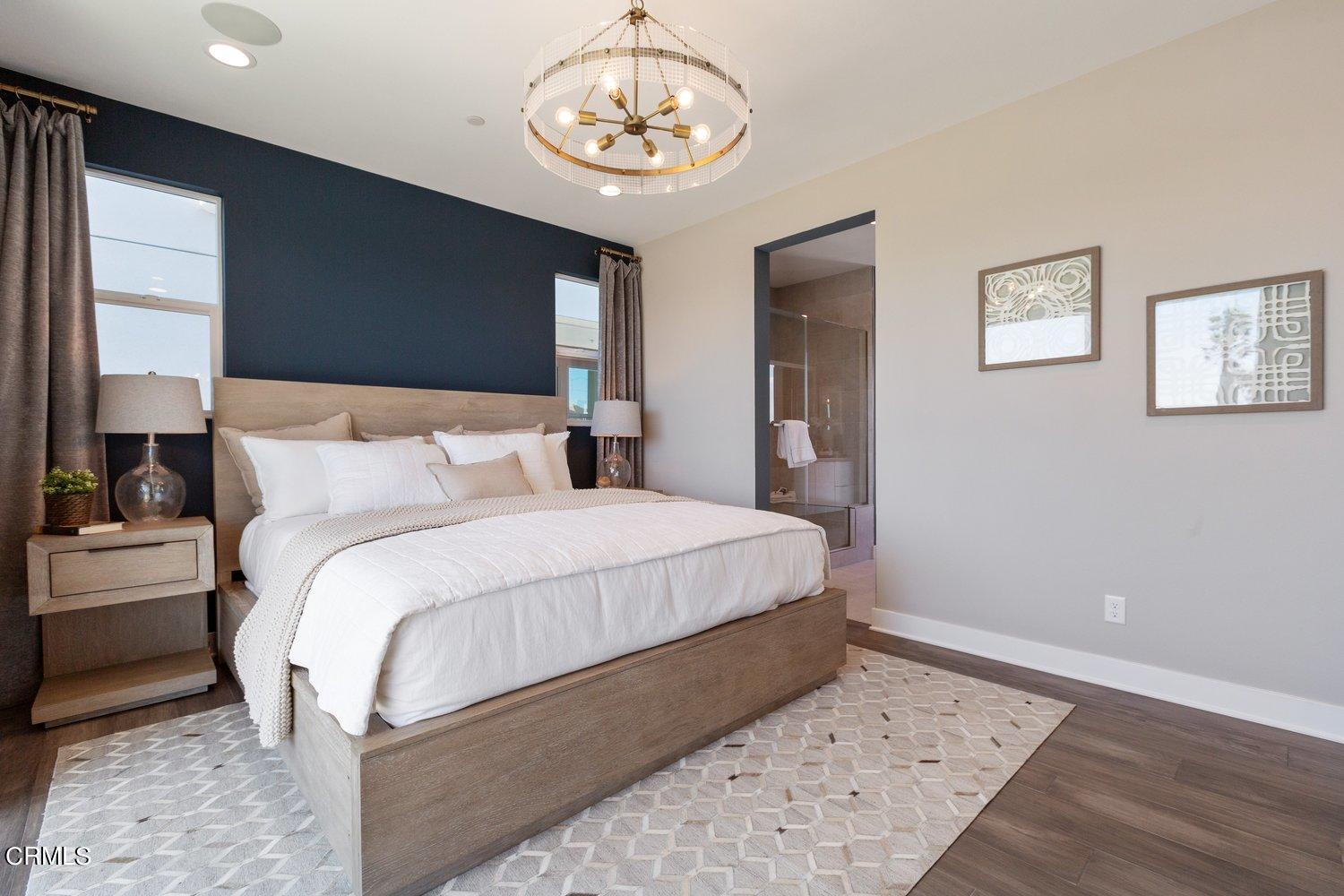 1030 Harbor Boulevard Oxnard, CA 93035 - Photo 11 of 24 a bedroom with a large bed and a chandelier