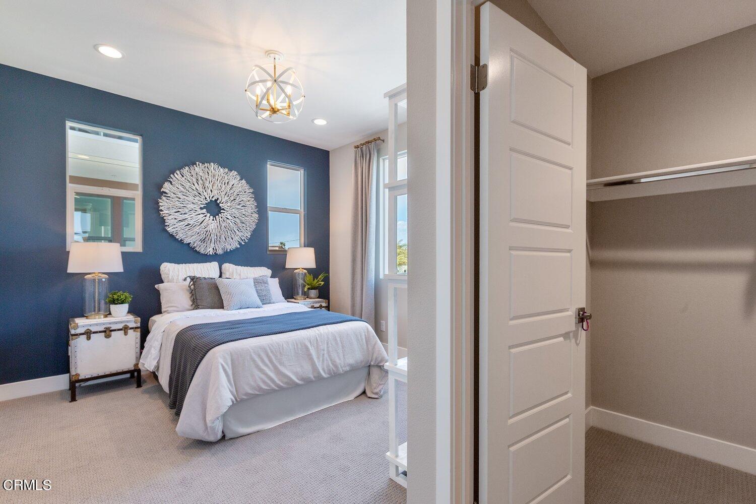 1030 Harbor Boulevard Oxnard, CA 93035 - Photo 16 of 24 a bedroom with a bed and a chandelier