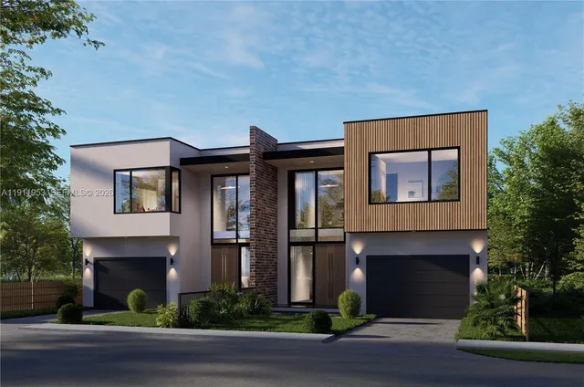 a aerial view of a house with a yard balcony and garage