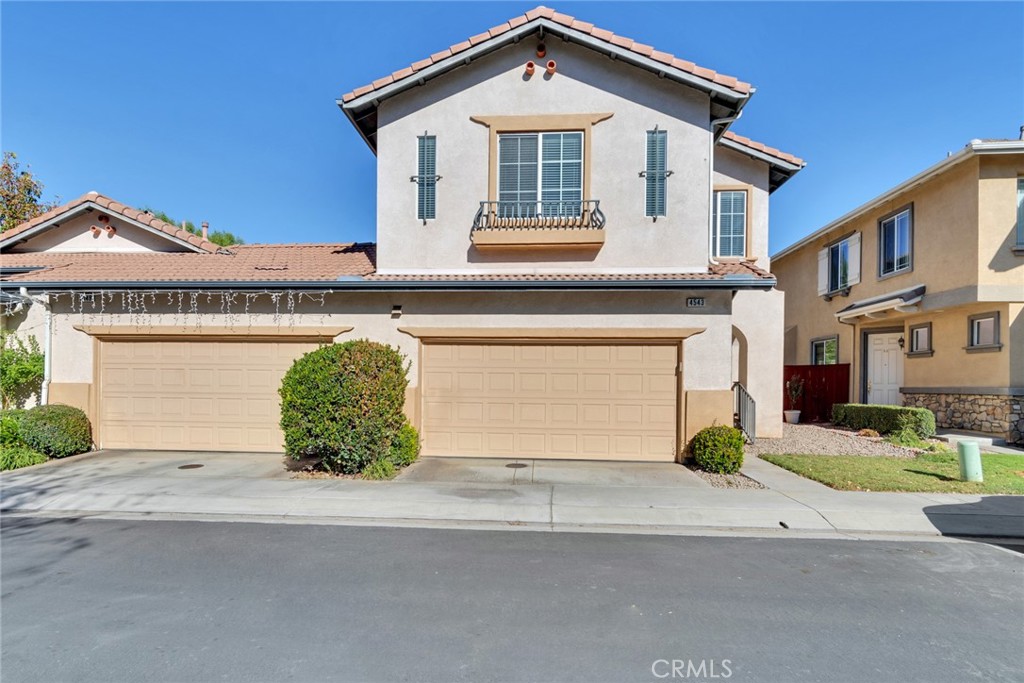 4543 Riverscape Drive Riverside, CA 92505 - Photo 2 of 25 a front view of a house with a garden and garage