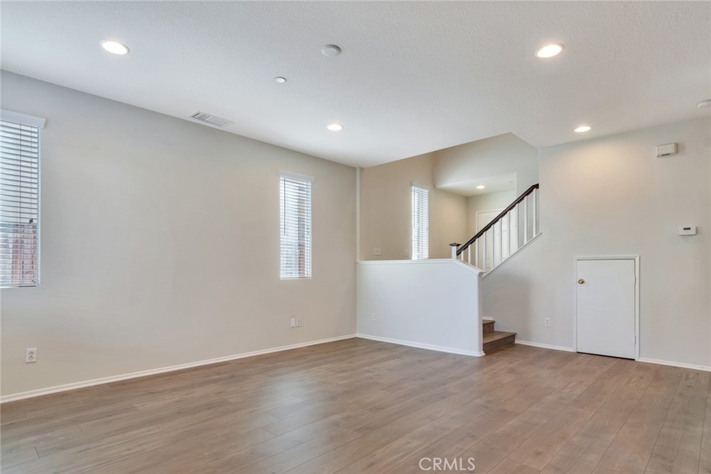 4543 Riverscape Drive Riverside, CA 92505 - Photo 5 of 25 an empty room with wooden floor and stairs