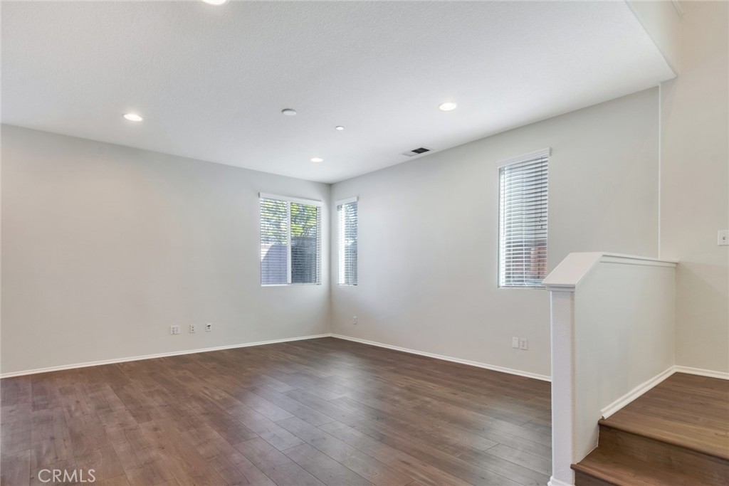 4543 Riverscape Drive Riverside, CA 92505 - Photo 6 of 25 an empty room with wooden floor and windows