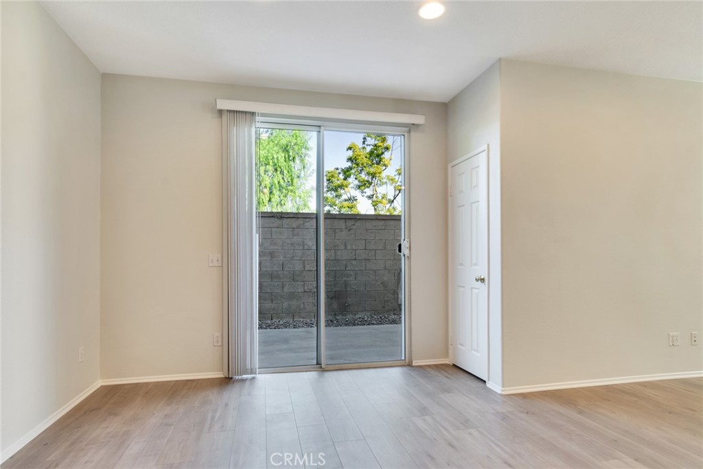 4543 Riverscape Drive Riverside, CA 92505 - Photo 8 of 25 an empty room with wooden floor and windows