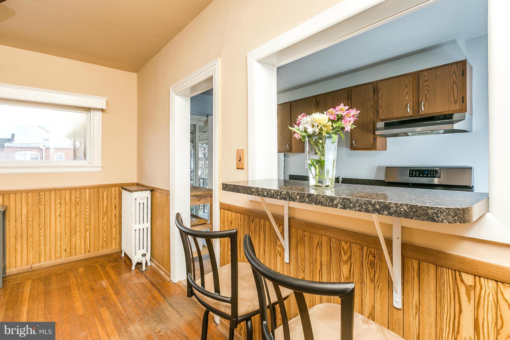 3609 Yolando Road Baltimore, MD 21218 - Photo 12 of 27 a view of a kitchen area with furniture and wooden floor
