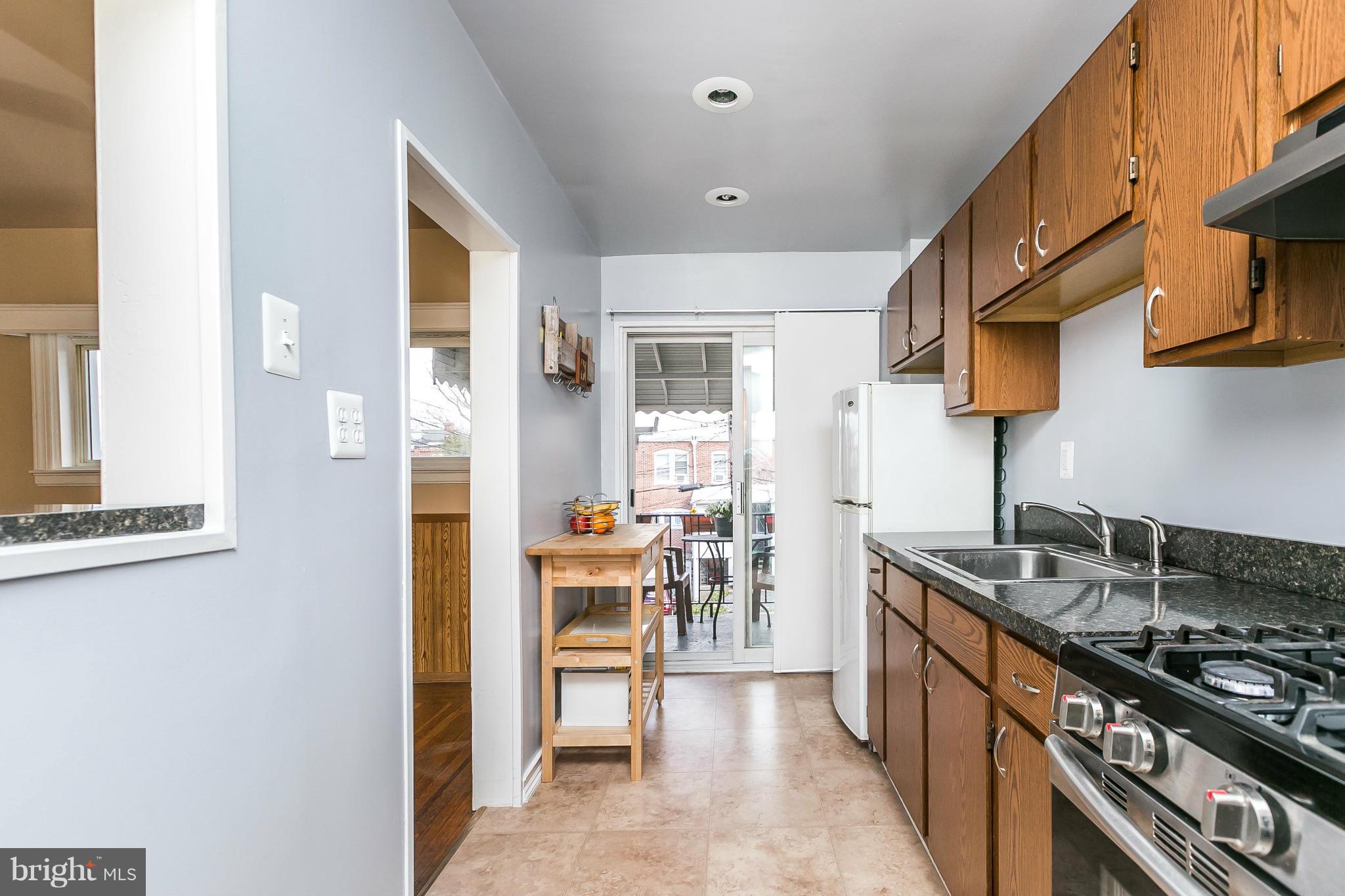 3609 Yolando Road Baltimore, MD 21218 - Photo 14 of 27 a kitchen with stainless steel appliances granite countertop a stove a sink and a refrigerator